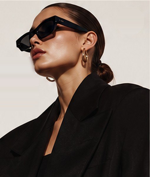 Model in black sunglasses and a tailored black blazer